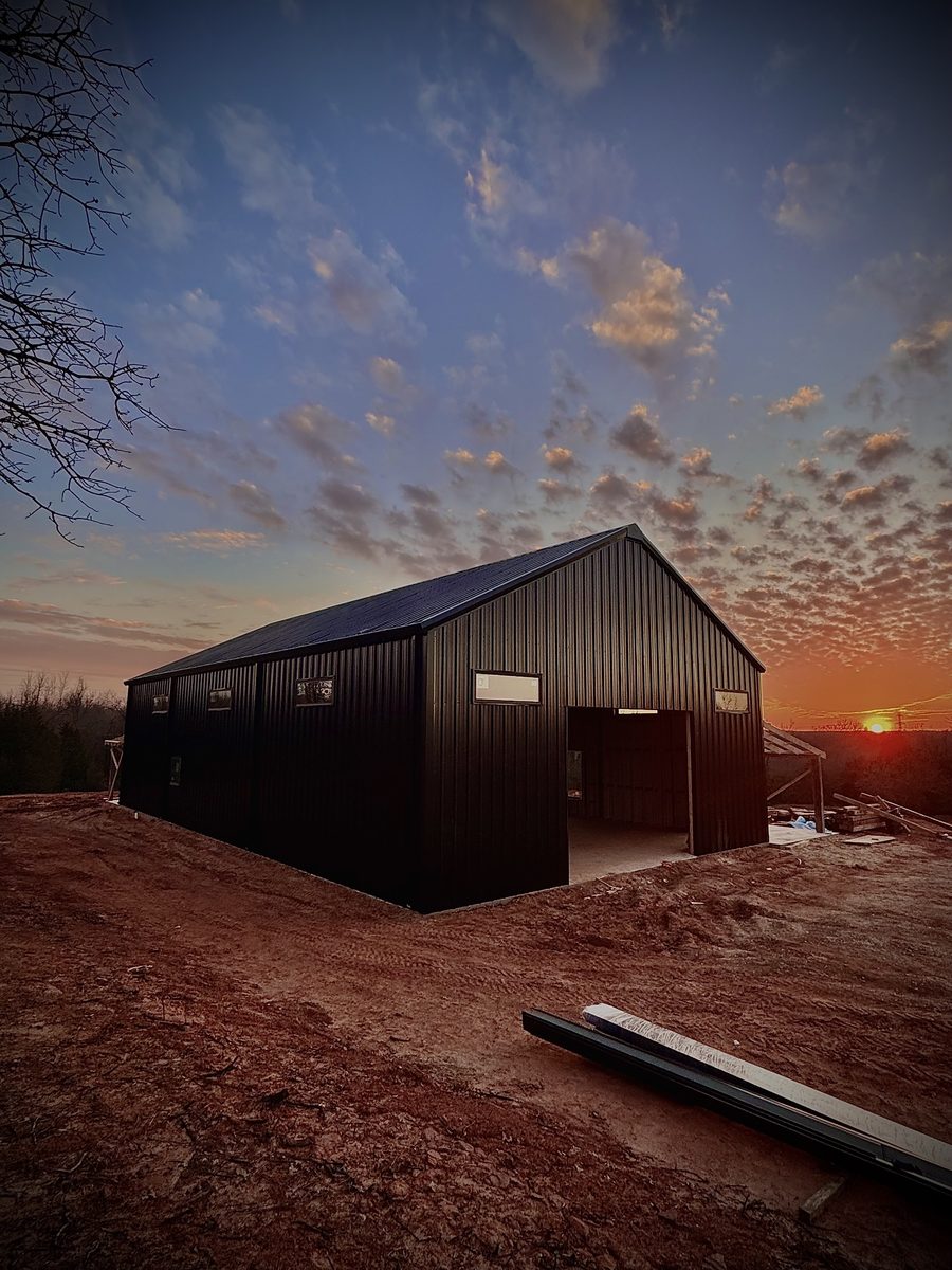Black metal building Oklahoma dusk